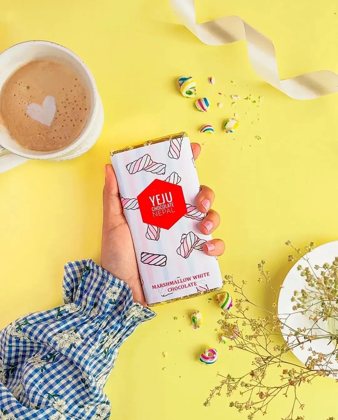 Marshmallow white chocolate bar in hand
